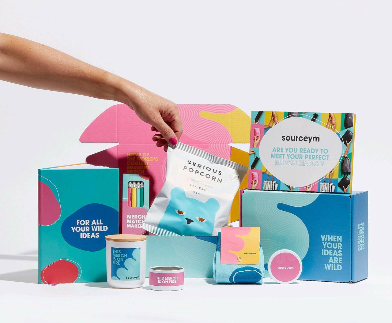 Hand reaching into an open pink and yellow